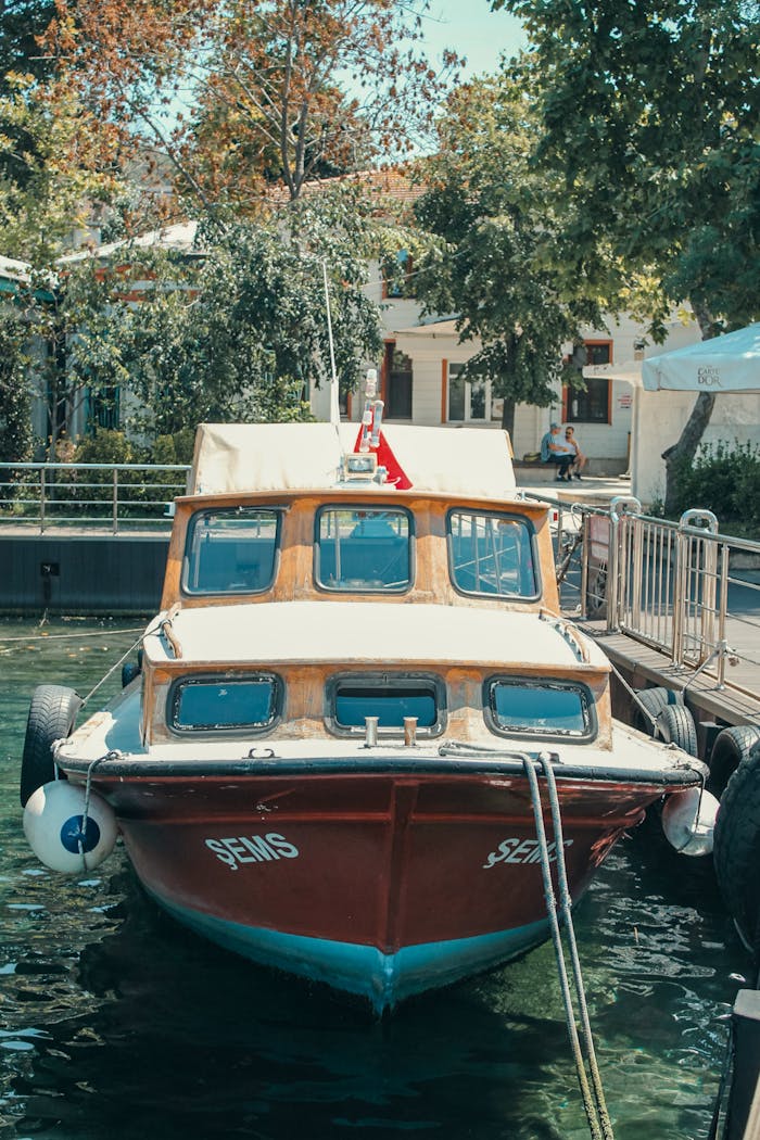 A scenic view of a wooden boat docked at a picturesque harbor pier in Istanbul, Türkiye.