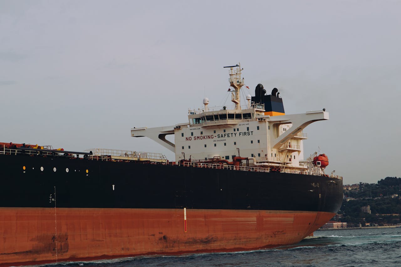 A large cargo ship with 'No Smoking Safety First' sign sailing at sea.